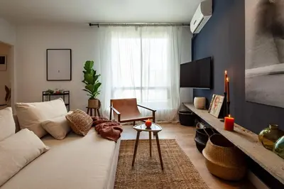 a living room with a white couch and a tv at The Collection Barcelona - Plaza Catalunya cozy 4 Bedroom in Barcelona