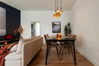 a living room with a table and a couch at The Collection Barcelona - Plaza Catalunya cozy 4 Bedroom in Barcelona