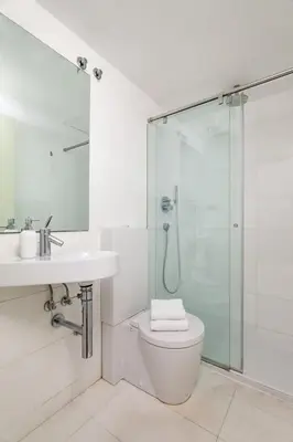a bathroom with a toilet and a glass shower at The Collection Barcelona - Plaça Catalunya Modern 2bedroom with balcony in Barcelona
