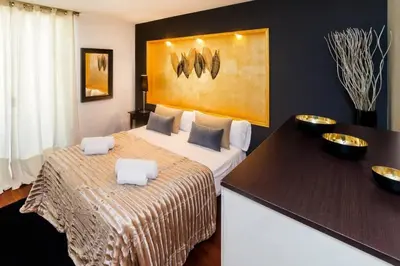 a hotel room with a bed with two bowls on it at The Collection Barcelona - Luxury Duplex Apartment in the Heart of Barcelona in Barcelona