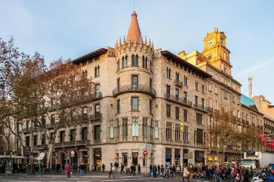 a large building on a street with people walking around it at The Collection Barcelona - Luxury Duplex Apartment in the Heart of Barcelona in Barcelona