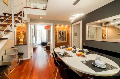 a kitchen and dining room with a table and chairs at The Collection Barcelona - Luxury Duplex Apartment in the Heart of Barcelona in Barcelona