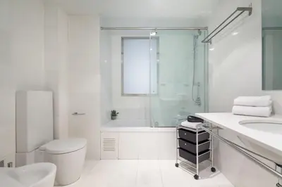 a bathroom with a toilet and a glass shower at The Collection Barcelona - Plaça Catalunya 3bedroom Duplex with Balcony in Barcelona