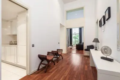 a quotationatory logo with a magnifying glass at The Collection Barcelona - Plaça Catalunya 3bedroom Duplex with Balcony in Barcelona