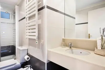 a white room with an orange painting on the wall at The Collection Barcelona - Central and Elegant 4 Bedroom by Placa Catalunya in Barcelona