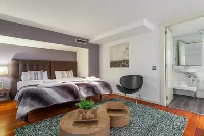 a living room with a couch and a table at The Collection Barcelona - 3bedroom Duplex with balcony in plaza Cataluña in Barcelona