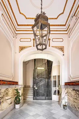 a lobby with a large door and a chandelier at The Collection Barcelona - Ronda Sant Pere Private City Center 3Bedroom Suite B in Barcelona