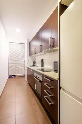 a bedroom with two beds and a cabinet at The Collection Barcelona - Plaza Urquinaona 3-Bedroom Suite in Barcelona