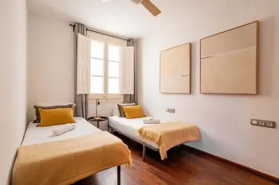 a living room with a couch and a table at The Collection Barcelona - Plaza Urquinaona 3-Bedroom Suite in Barcelona