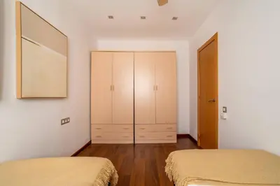 a quotationatory logo with a magnifying glass at The Collection Barcelona - Plaza Urquinaona 3-Bedroom Suite in Barcelona