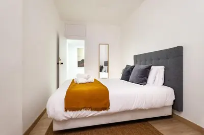 a living room with a table and a potted plant at The Collection Barcelona - Exclusive Huge 4 Double Bedroom City Center in Barcelona