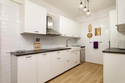 a white bathroom with a sink and a mirror at The Collection Barcelona - Exclusive Huge 4 Double Bedroom City Center in Barcelona