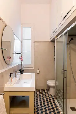 a bathroom with a sink and a mirror and a shower at The Collection Barcelona - Placa Catalunya V Charming and Exquisite 5Bd Apartment with Large Balcony in Barcelona