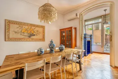 a dining room with a wooden table and chairs at The Collection Barcelona - Huge historic 5BD with private Terrace! in Barcelona