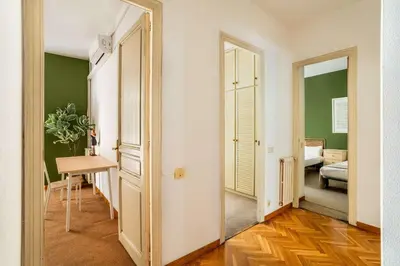 a hallway with a door leading to a room with green walls at The Collection Barcelona - Huge historic 5BD with private Terrace! in Barcelona