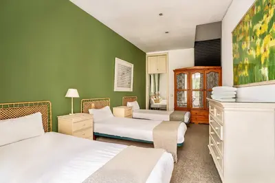 two beds in a room with green walls at The Collection Barcelona - Huge historic 5BD with private Terrace! in Barcelona