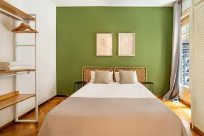 a bedroom with a bed with a green wall at The Collection Barcelona - Huge historic 5BD with private Terrace! in Barcelona
