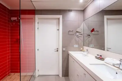 a bathroom with a sink and a shower with red tiles at The Collection Barcelona - Classy 3bed 3bath apartment in Eixample in Barcelona