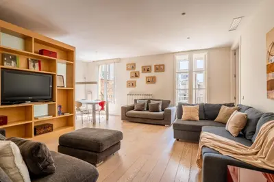 a living room with couches and a flat screen tv at The Collection Barcelona - Classy 3bed 3bath apartment in Eixample in Barcelona