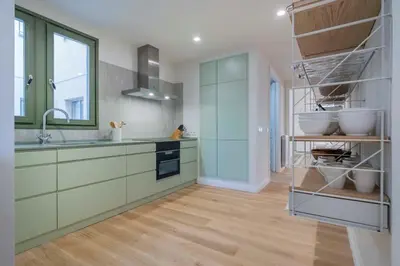 a kitchen with green cabinets and a sink at The Collection Barcelona - Amazing 5 bd 5 bathroom next to Plaza Catalunya in Barcelona