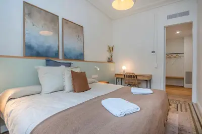 a bedroom with a large bed with two towels on it at The Collection Barcelona - Amazing 5 bd 5 bathroom next to Plaza Catalunya in Barcelona