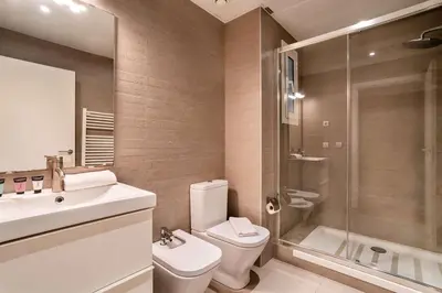 a bathroom with a toilet and a sink and a shower at The Collection Barcelona - Perfectly located 4bed 4bath apartment in Eixample in Barcelona