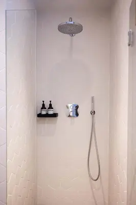 a bathroom with a shower with a camera in it at Apartamento ático en el casco antiguo in Mataró