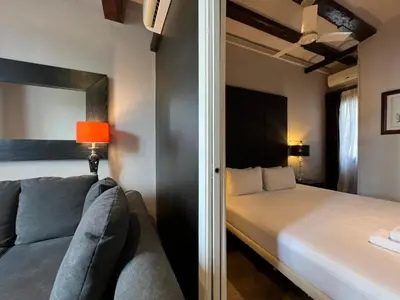 a bedroom with a bed and a couch in a room at Stay U-nique Apartments Est in Barcelona
