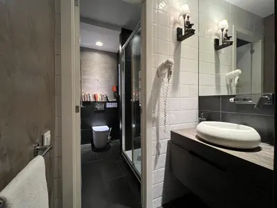 a bathroom with a sink and a toilet and a mirror at Stay U-nique Apartments Est in Barcelona