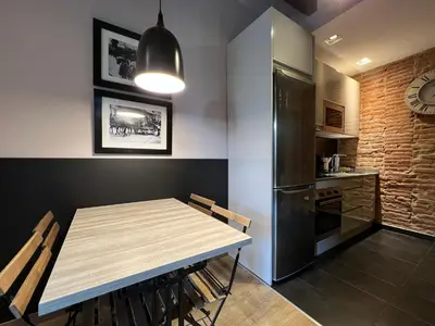 a dining room with a table and a refrigerator at Stay U-nique Apartments Est in Barcelona
