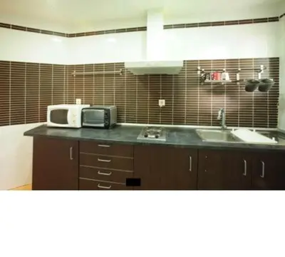 a kitchen with a microwave and a sink at GOOD APARTMENTS gran via 3 bedrooms in Barcelona