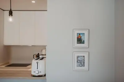 a kitchen with three framed pictures on the wall at Petit Luxe Volta Apartaments in Terrassa