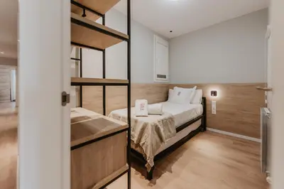 a small bedroom with a bed and a bunk room at Petit Luxe Volta Apartaments in Terrassa