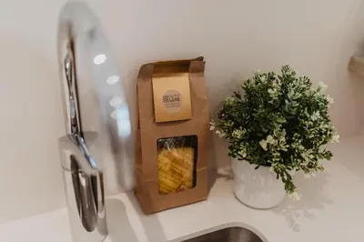a bag of chips on a counter next to a plant at Petit Luxe Volta Apartaments in Terrassa