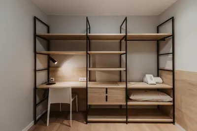 a room with bunk beds and a desk at Petit Luxe Volta Apartaments in Terrassa