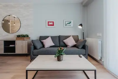 a living room with a couch and a table at Petit Luxe Volta Apartaments in Terrassa