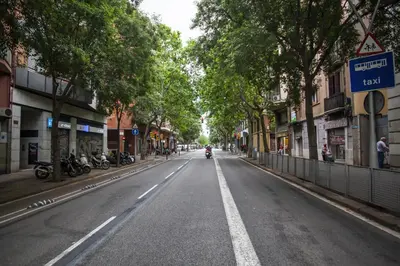 an empty street with a motorcycle driving down the street at 63MAL1030 - Beautiful apartment near the Sagrada in Barcelona