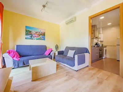 a living room with a blue couch and a table at Absolute Sagrada Familia in Barcelona