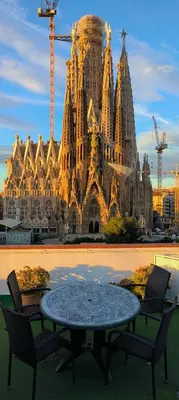 a table and chairs in front of a large building at Absolute Sagrada Familia in Barcelona