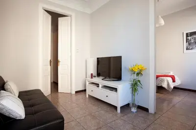 a living room with a tv on a white cabinet at Whatching Sagrada Familia in Barcelona