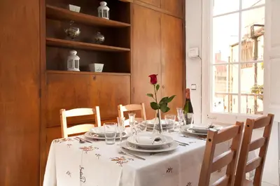 a table with a white table cloth and a flower on it at Whatching Sagrada Familia in Barcelona