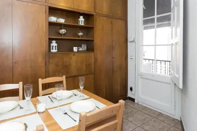 a dining room with a table and chairs and a window at Whatching Sagrada Familia in Barcelona