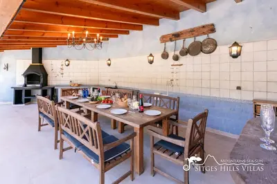 a patio with an umbrella and a swimming pool at Spacious Villa Santa Fe - private pool, big garden and A/C close to Sitges in Olivella