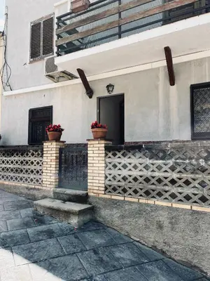 a building with two flower pots on the side of it at Casa iaia in Monistrol