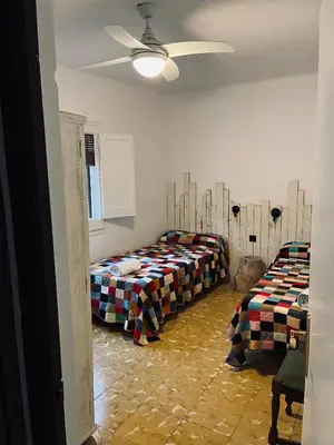 a room with three beds and a ceiling at Casa iaia in Monistrol