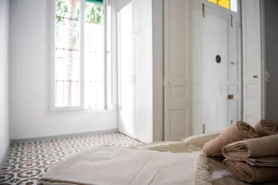 a bedroom with a bed with towels on it at Hauzify I Apartament Can Missé in Calella