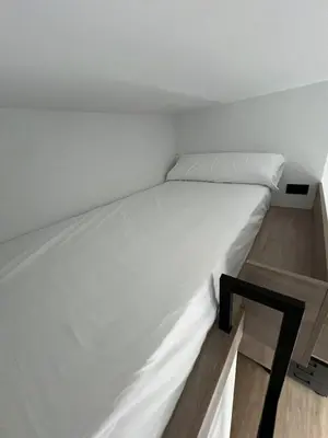 a small bedroom with a white bed in a room at Micampus Barcelona Student Residence in Barcelona