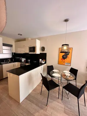 a kitchen and dining room with a table and chairs at Gracia Barcelona Apartment in Barcelona