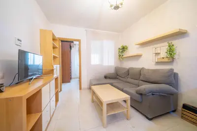 a living room with a couch and a tv at HomeHolidaysRentals Milos - Costa Barcelona in Pineda de Mar