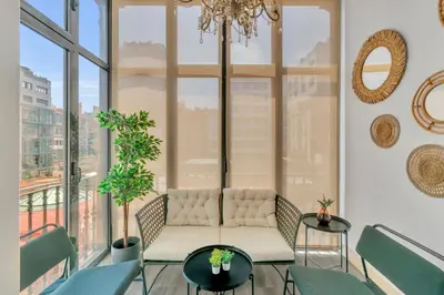a living room with a couch in front of a window at Tendency Apartments 6 in Barcelona